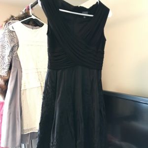 Knee length black dress with design on bottom half